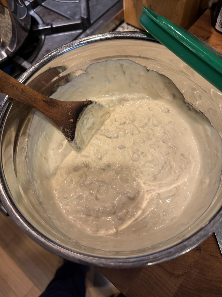 Onion dip mixed together in a bowl with sour cream and mayo